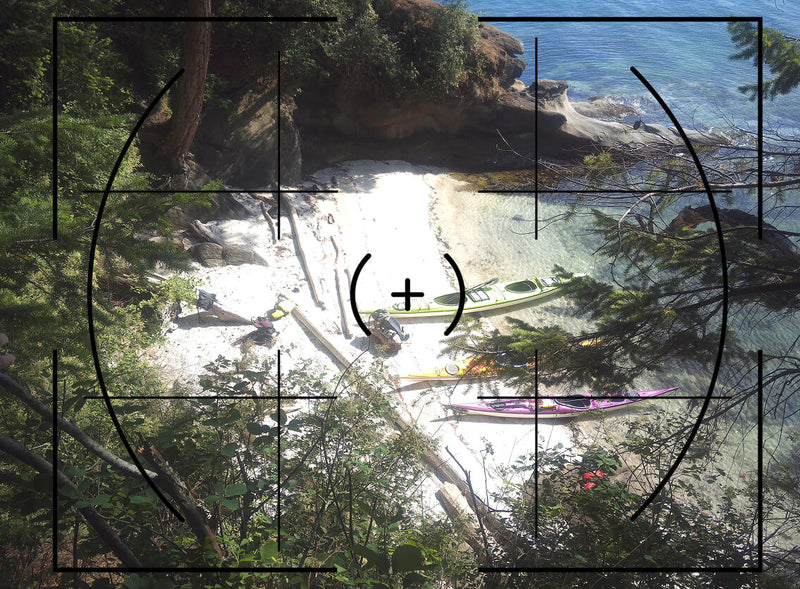 Kayaks on a beach seen through the Portal AFN7 viewfinder crosshairs