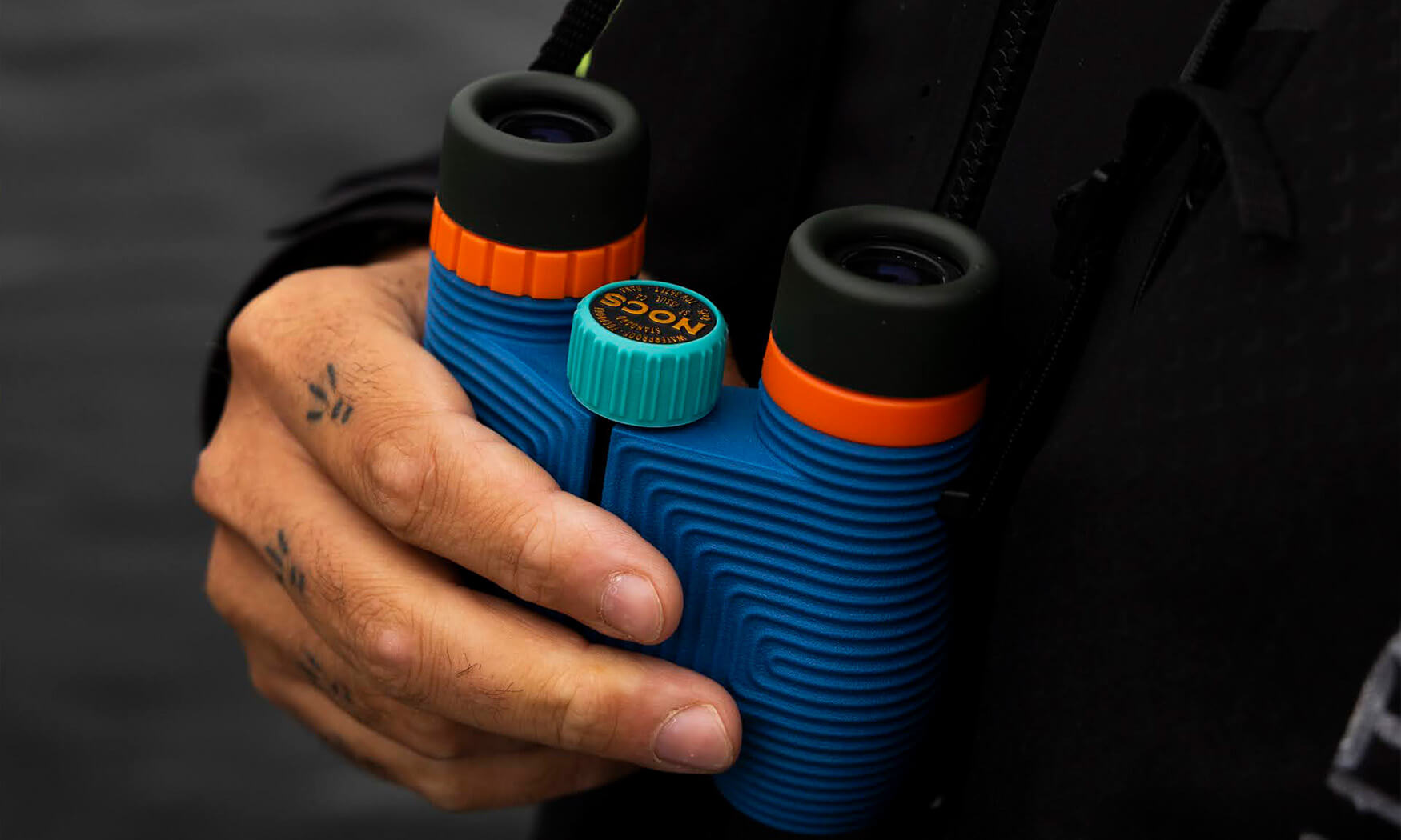 Nocs Standard Issue 8x25 binoculars being used outdoors in the field — ideal for situational awareness, route scouting, and perimeter watch in emergency preparedness scenarios